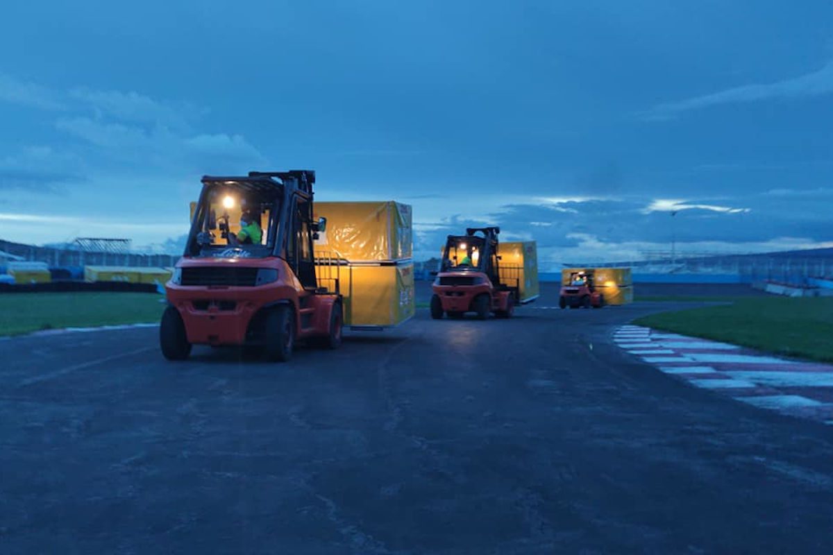 Forklifts delivering freight to a motor sports event
